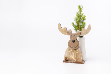 Miniature toy retro sled with little fur tree on white background. Wooden model.