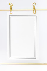 Little fir tree in ceramic vase and golden frame on white background. Christmas card - toys, garlands and wooden thinks.