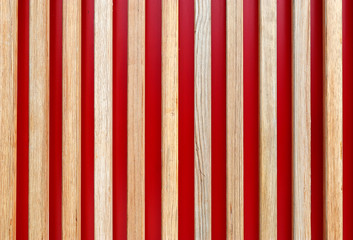Wooden planks on a red background. Vertically arranged boards on a red background