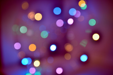 Night city lights on Christmas night. New Year, colored garland in defocus. Multi-colored bokeh on a light background for Photoshop.
