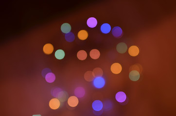 Night city lights on Christmas night. New Year, colored garland in defocus. Multi-colored bokeh on a dark background for photoshop.