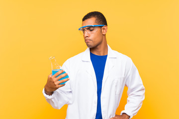 Scientific man holding a laboratory flask over isolated background