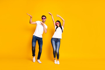 Full length photo of two crazy people dancing at first season theme party wear cool specs and...