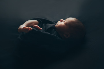 the concept of healthy lifestyle, IVF - a newborn baby sleeps under a blanket. Head, legs and arms