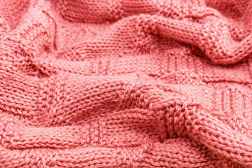 Fototapeta na wymiar Knitted pink background. Pink knitted crumpled fabric.