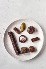 Assortment of fine chocolate candies on a ceramic plate. 