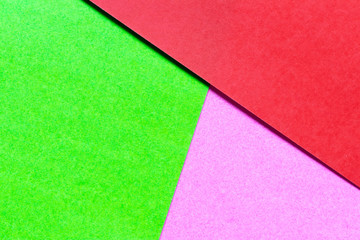 Fototapeta premium Abstract green, pink and red color paper textured background with copy space for design and decoration