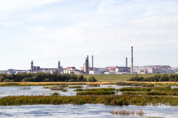 Fototapeta na wymiar Industry and wildlife. Mining industry. The combination of nature and technology. Ore mining. The extraction of potassium salt. Belarus. Salihorsk. The mine on the background of the river.