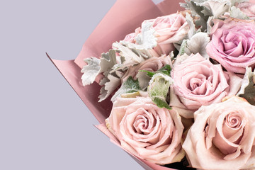 beautiful bouquet of red roses in pastel pink packaging isolated on white