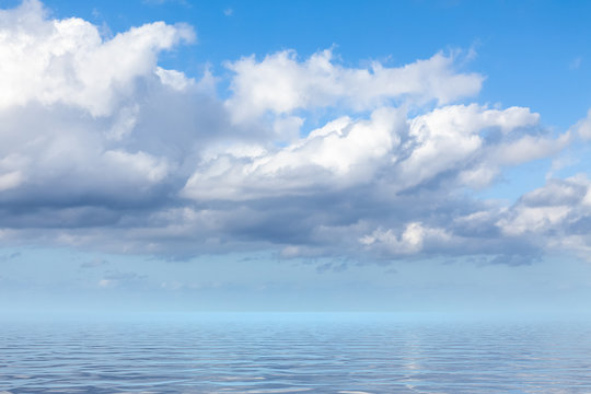 blue sky with white clouds over the sea