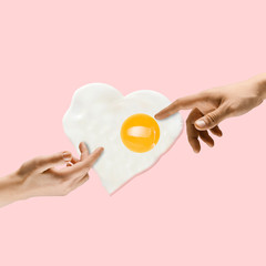 An alternative food. Touch of God - two hands and fried egg against trendy coral background. Negative space to insert your text. Modern design. Contemporary colorful and conceptual bright art collage.