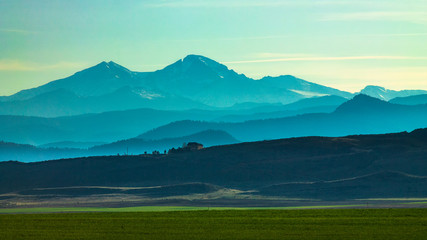 Overlook of mountain range and farmland in afternoon light