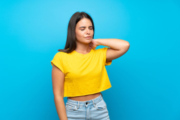 Young girl over isolated blue background with neckache