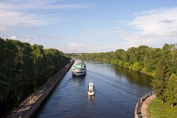 Uglich. cruise ship passes through the gateway of the Uglich hydroelectric power station
