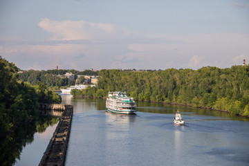 Uglich. cruise ship passes through the gateway of the Uglich hydroelectric power station