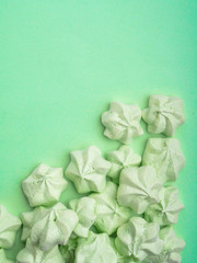 mint green meringues over mint backdrop with copy space