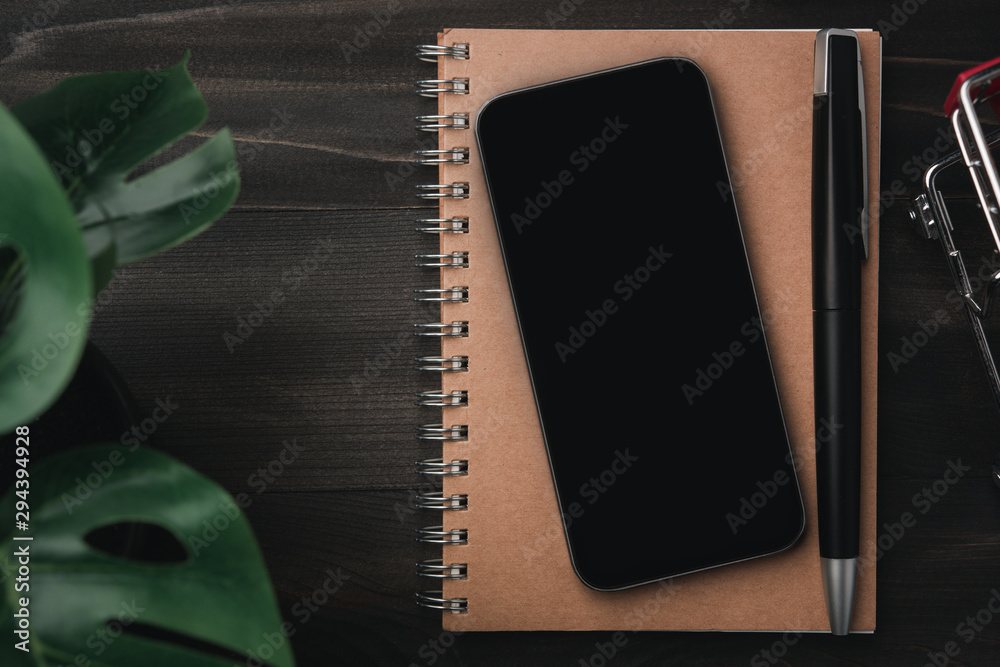 Poster creative workspace modern dark office desk with blank smartphone and pen on notebook,mockup topview