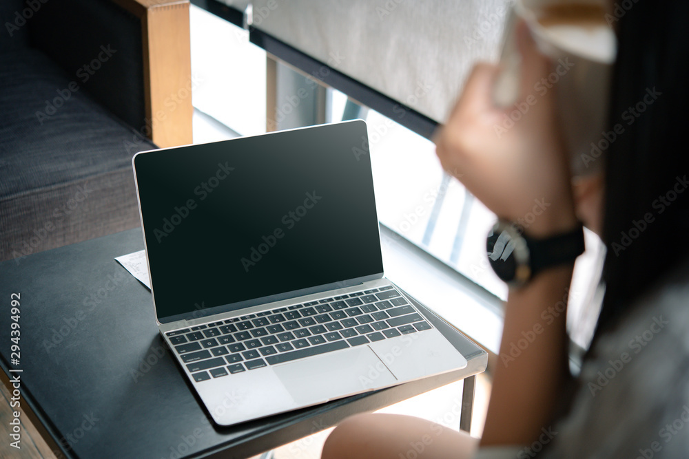 Poster business woman working on computer with empty blank screen in the coffee shop, concept freedom of wo