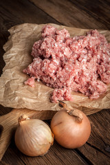 Minced meat on wooden background.