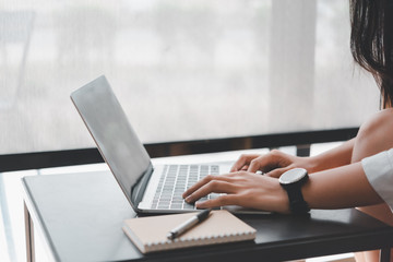  woman hand using computer laptop in coffee shop. with copy space for text or design and Advertisement.
