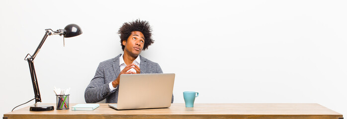 young black businessman scheming and conspiring, thinking devious tricks and cheats, cunning and...