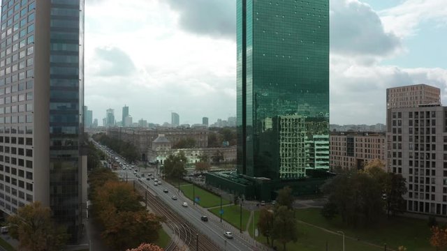Drone shot between two skyscrapers towards the city center. Aerial view of the financial district in Warsaw, Poland.  06. October.  2019. Cityscape and modern skyscrapers. Drone Shot 4K.