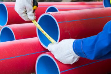 close-up, tape measures for measuring the diameter of plastic red pipes, for laying electrical...