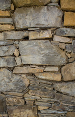 The texture of the stone. Masonry fence. A variety of stone textures in different colors, sizes and shapes.
