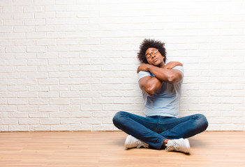 young black man feeling in love, smiling, cuddling and hugging self, staying single, being selfish...