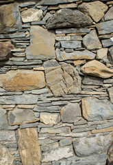 The texture of the stone. Masonry fence. A variety of stone textures in different colors, sizes and shapes.