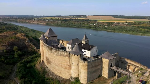 Aerial view of Hotyn medieval castle on the green hill above the river. Zoom in.