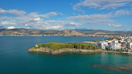 Naklejka na ściany i meble Aerial drone photo of iconic lighthouse built in small islet in famous city of Halkida or Chalkida with clear water seascape and beautiful sky - clouds, Evia island, Greece