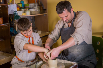 Potter showing how to work with ceramic in pottery studio