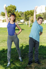 Obraz premium Mother and son stretching outdoors