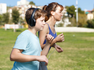 Mother and son running together