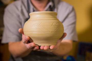 Fototapeta na wymiar Potter showing earthenware pot