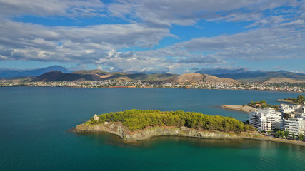 Fototapeta premium Aerial drone photo of iconic lighthouse built in small islet in famous city of Halkida or Chalkida with clear water seascape and beautiful sky - clouds, Evia island, Greece