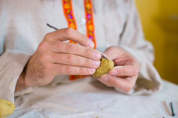 Potter making clay figure for board game