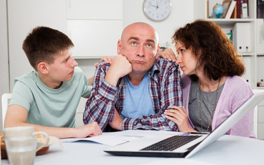 Wife with teenager comforting upset man