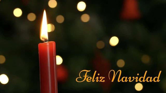 Feliz Navidad written over lit candle