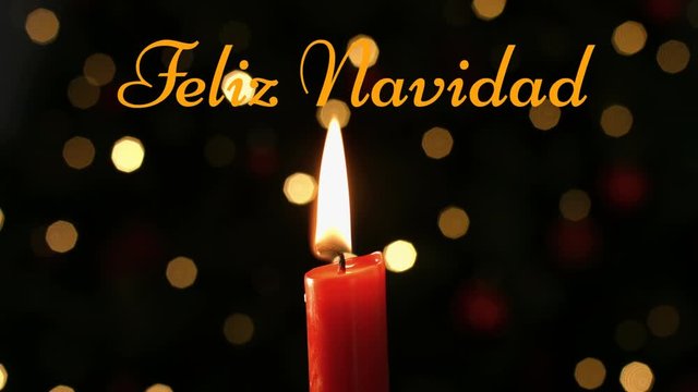 Feliz Navidad written over lit candle