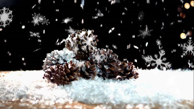 Snow falling on pine cones