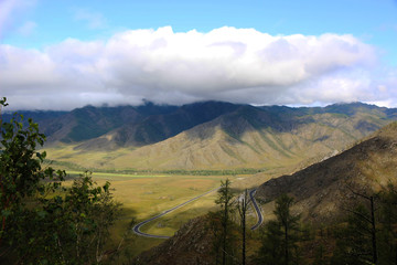 Fototapeta premium Beautiful scenery. The natural background. Mountains, river, waterfall, grass, trees, blue sky with clouds. 
