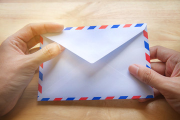 Hand opening air mail envelope