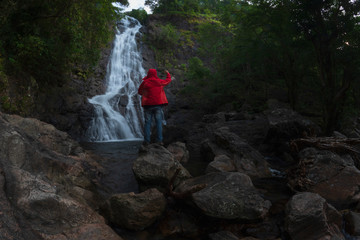 Obraz premium waterfall in national on mountain. hiker in the mountains