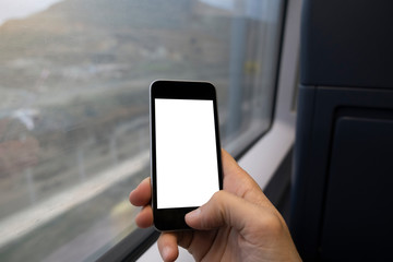a man holding mobile phone inside of train