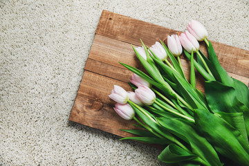 Pink tulip flowers on the wooden board