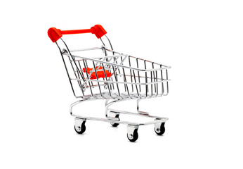 Perspective view of empty grocery toy shopping cart with red handle isolated on white background, suitable for marketing and shopping product advertisement.