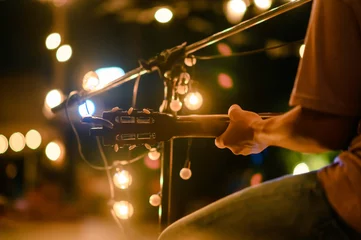  guitar, song, concert, music, musical, entertainment, musician, Rear view of the man sitting play acoustic guitar on the outdoor concert with a microphone stand in the front, musical concept. © Day Of Victory Stu.