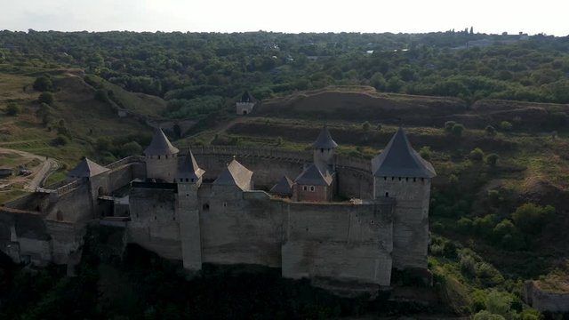 Aerial view of old castle near the River. Hotyn Castle in Ukraine. Eastern Europe. Tracking from left to right.